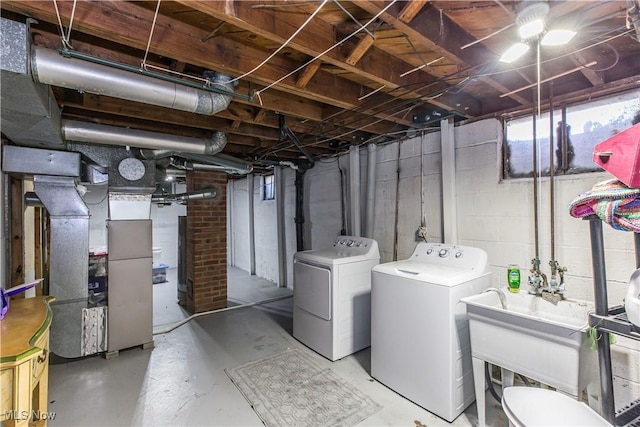 below grade area with heating unit, washing machine and dryer, and a sink