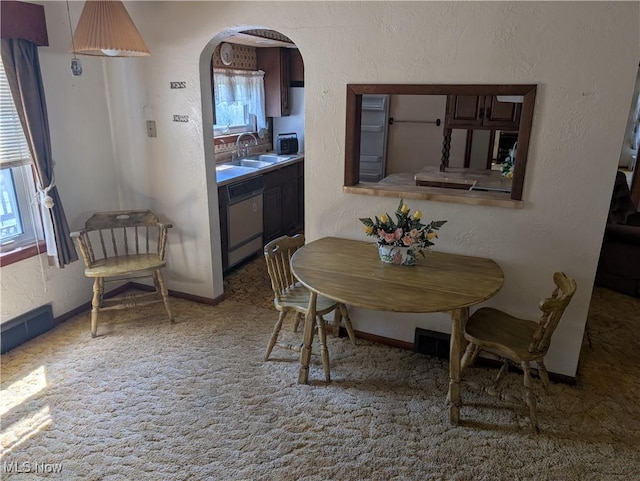 dining space featuring arched walkways