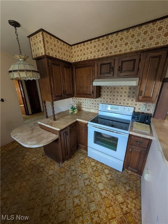kitchen featuring white range with electric stovetop, light countertops, dark brown cabinets, and under cabinet range hood