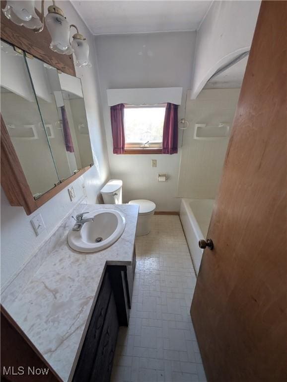 bathroom featuring walk in shower, a bathing tub, vanity, and toilet