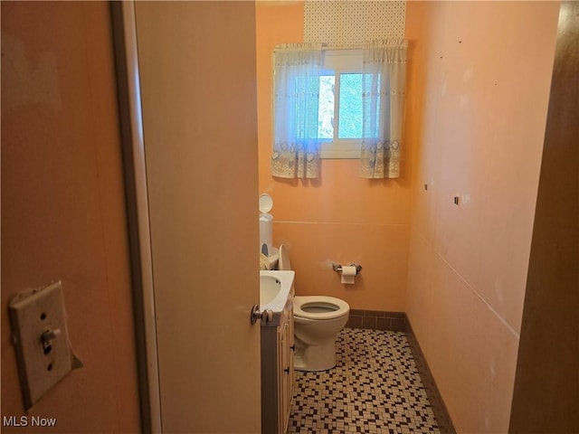 bathroom featuring toilet and vanity