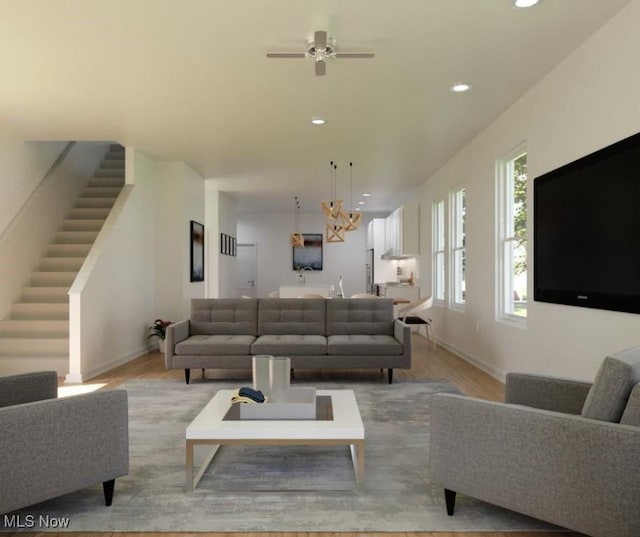 living room featuring wood finished floors, baseboards, recessed lighting, ceiling fan, and stairs