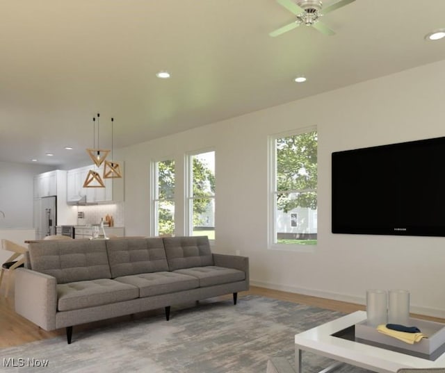 living area with light wood finished floors, recessed lighting, baseboards, and a ceiling fan