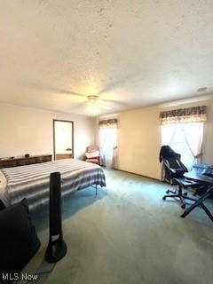 carpeted bedroom featuring a textured ceiling