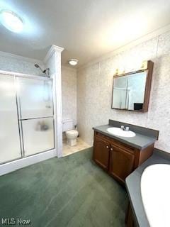 bathroom featuring toilet, a stall shower, crown molding, wallpapered walls, and vanity