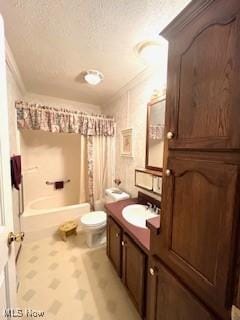 bathroom featuring toilet, vanity, ornamental molding, shower / bath combination with curtain, and a textured ceiling