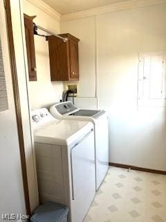 clothes washing area featuring washer and dryer, cabinet space, light floors, and crown molding