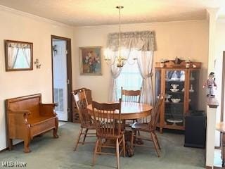 dining room with crown molding, an inviting chandelier, carpet flooring, and a healthy amount of sunlight