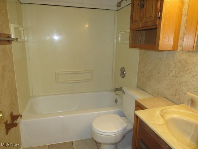 bathroom featuring tile patterned floors, bathing tub / shower combination, toilet, and vanity