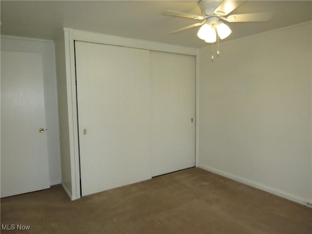 unfurnished bedroom with a ceiling fan, a closet, and carpet floors