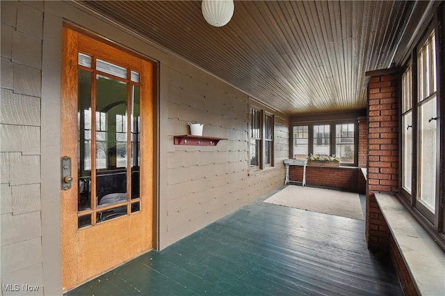 unfurnished sunroom featuring wood ceiling