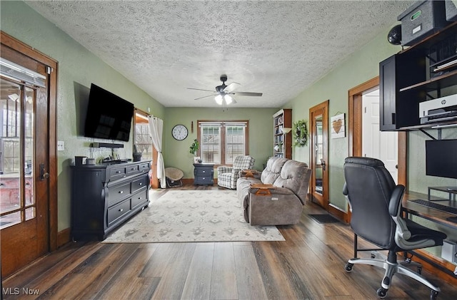 office space with dark wood finished floors, a textured ceiling, and a ceiling fan