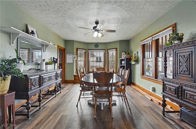 dining area with a textured ceiling, wood finished floors, baseboards, and ceiling fan