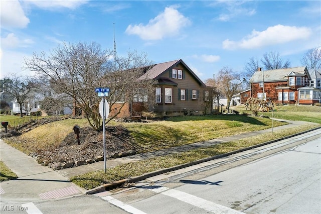 bungalow-style house featuring a front yard