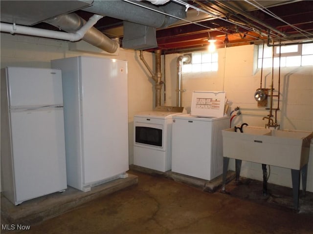 basement with independent washer and dryer and freestanding refrigerator