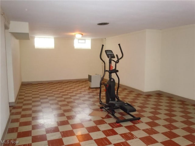 workout room featuring light floors and baseboards