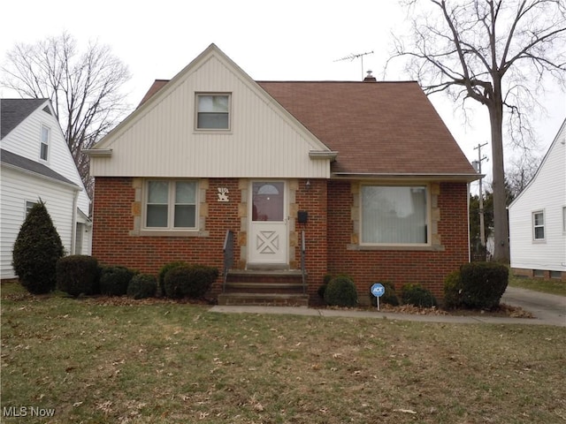 bungalow-style house featuring a front lawn and brick siding