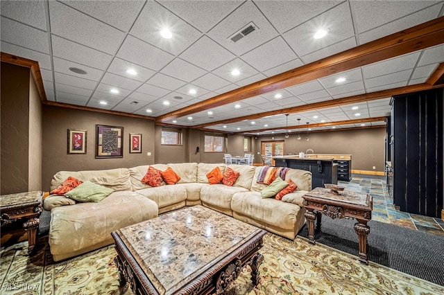 living area featuring baseboards, visible vents, recessed lighting, a paneled ceiling, and stone finish flooring