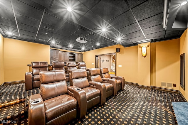 cinema room featuring visible vents, baseboards, and carpet