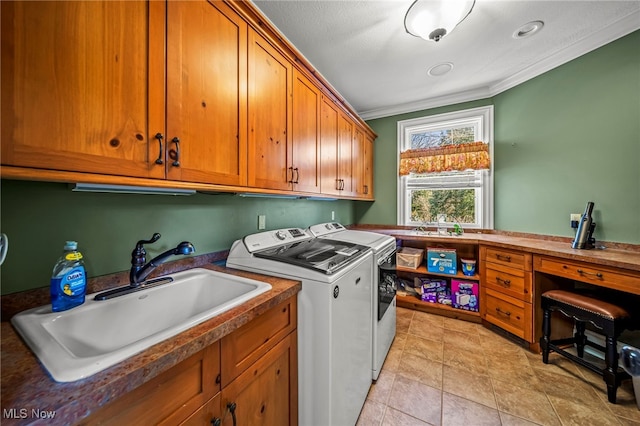 clothes washing area featuring independent washer and dryer, ornamental molding, a sink, cabinet space, and light tile patterned floors