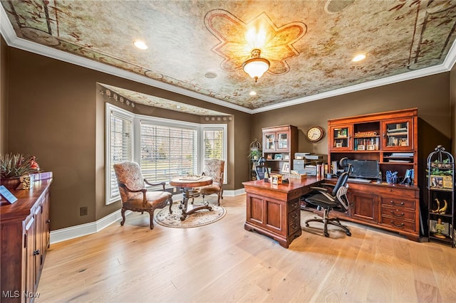 office area with baseboards, light wood-style flooring, and crown molding