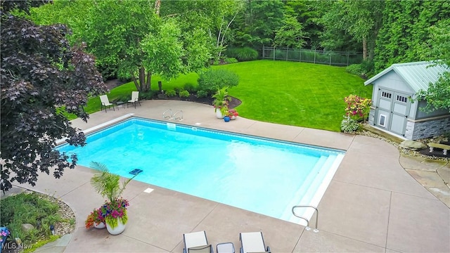 pool with a storage unit, fence, a yard, an outdoor structure, and a patio area