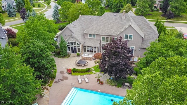 exterior space featuring an outdoor pool and a patio