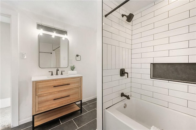 full bath featuring tile patterned flooring, vanity, bathing tub / shower combination, and baseboards