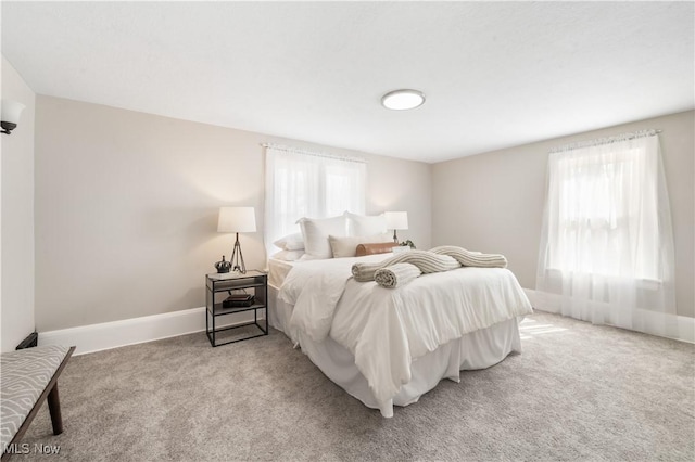 bedroom with baseboards and carpet floors