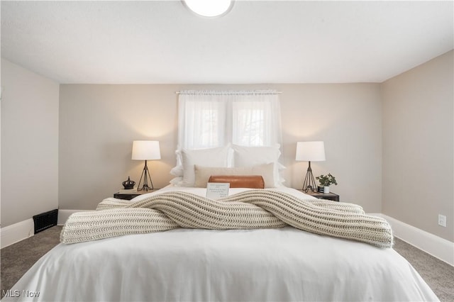 bedroom featuring baseboards and carpet