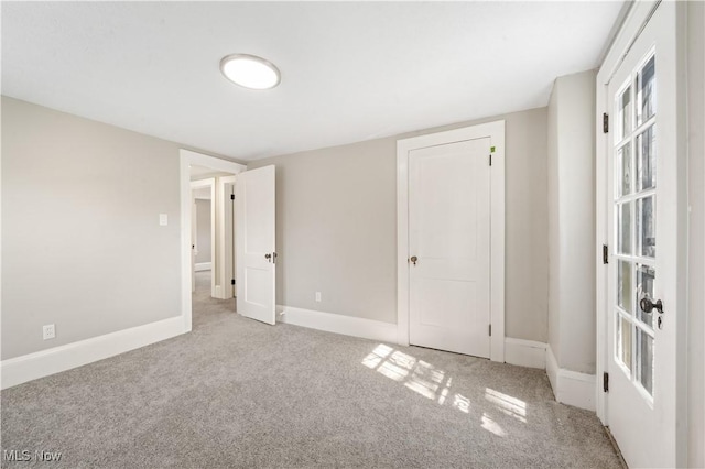 unfurnished bedroom featuring baseboards and carpet