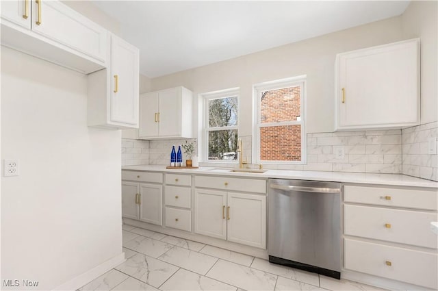 kitchen featuring a sink, light countertops, dishwasher, marble finish floor, and backsplash