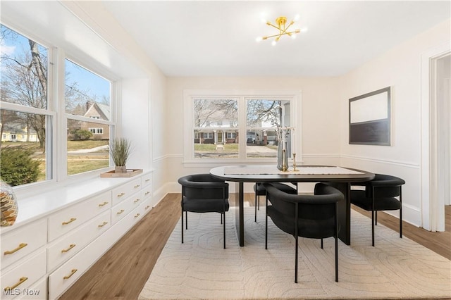 dining space featuring an inviting chandelier and wood finished floors