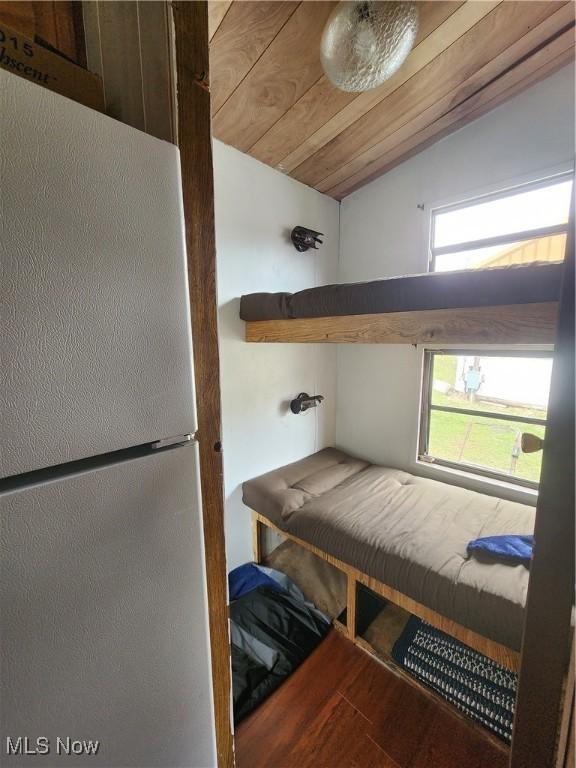 17875 Lashley Rd, Senecaville, OH 43780 - bedroom featuring lofted ceiling, wood ceiling, wood finished floors, and freestanding refrigerator