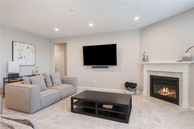 living room with recessed lighting, baseboards, carpet, and a fireplace