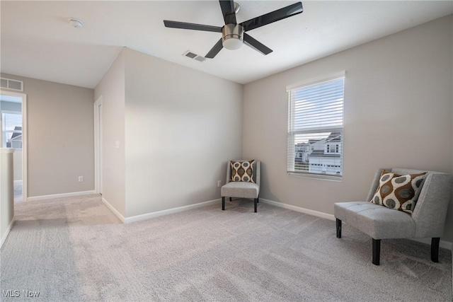 sitting room with visible vents, plenty of natural light, and carpet