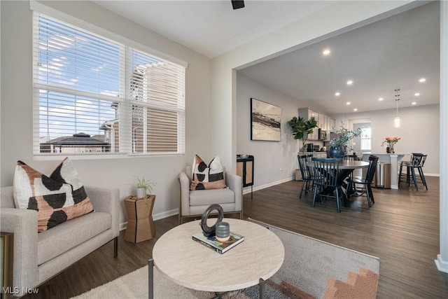 living room featuring recessed lighting, baseboards, and wood finished floors