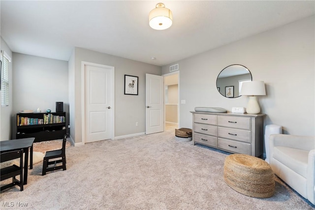 sitting room featuring visible vents, baseboards, and carpet