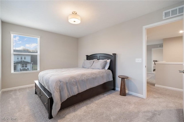 carpeted bedroom with visible vents and baseboards