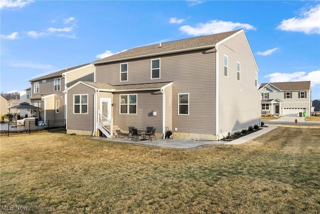 back of house featuring a lawn, entry steps, a patio, and fence