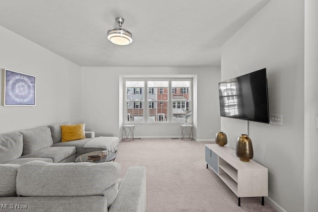 carpeted living room featuring baseboards