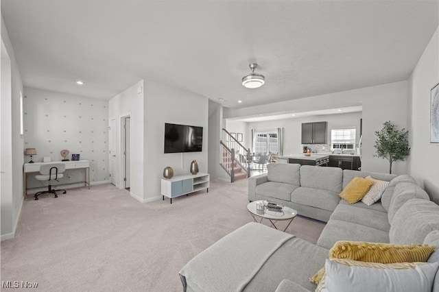 living room featuring stairs, recessed lighting, light colored carpet, and baseboards