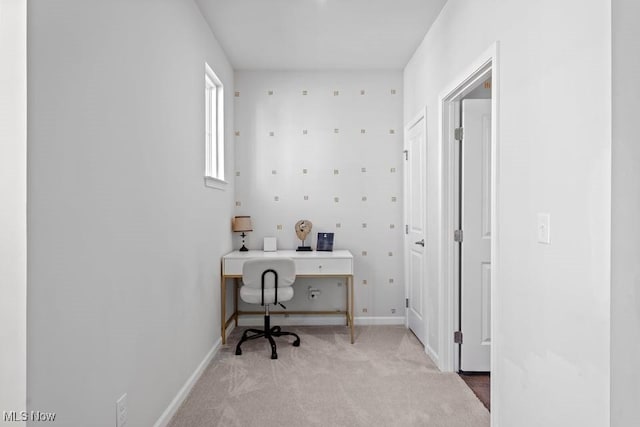 office space with baseboards and light colored carpet