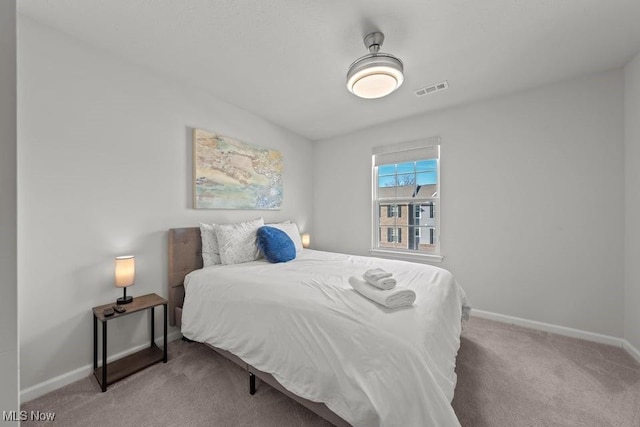 carpeted bedroom with baseboards and visible vents