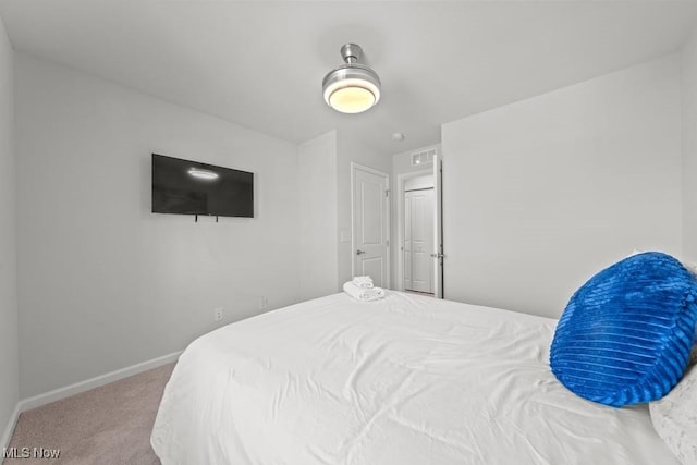 carpeted bedroom featuring baseboards