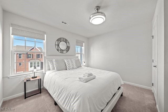 bedroom featuring carpet, visible vents, and baseboards