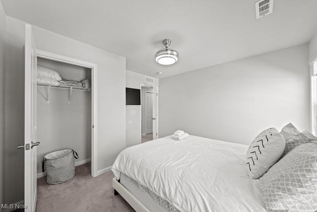 carpeted bedroom with a closet, baseboards, and visible vents