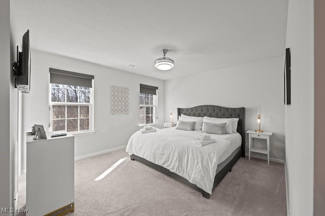 carpeted bedroom featuring multiple windows, visible vents, and baseboards