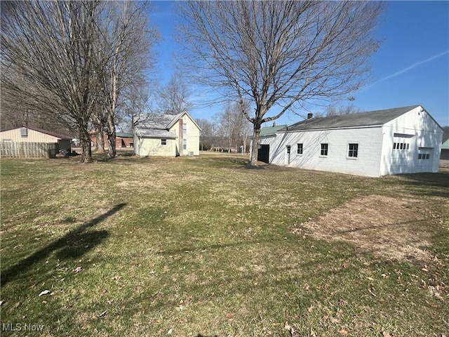 view of yard with a garage and an outdoor structure