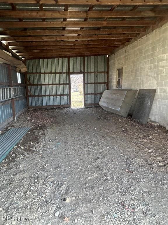 miscellaneous room featuring metal wall and concrete block wall